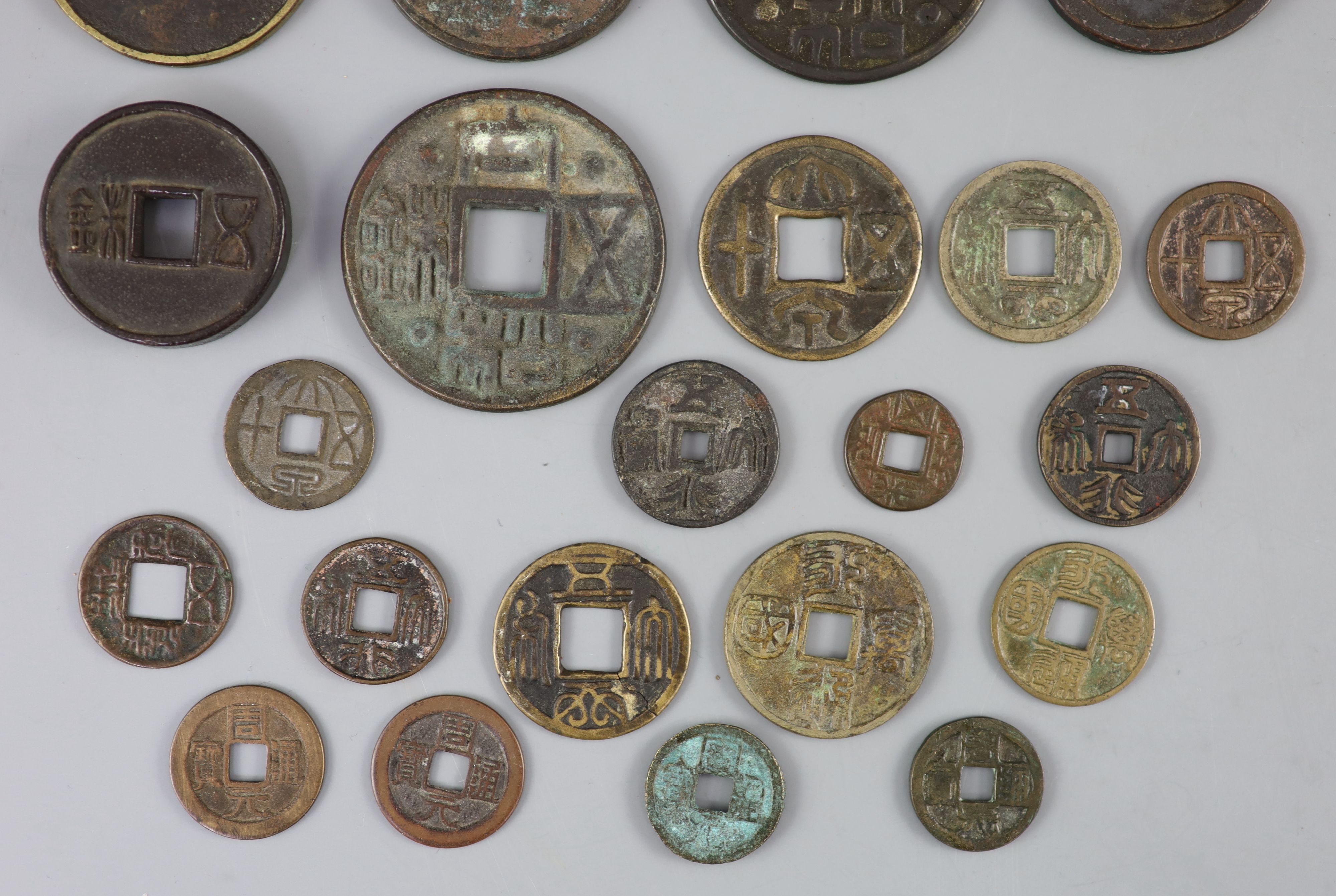 China, a group of 6 bronze coin charms or amulets, 19th century and various Thai (Siamese) porcelain gaming counters,